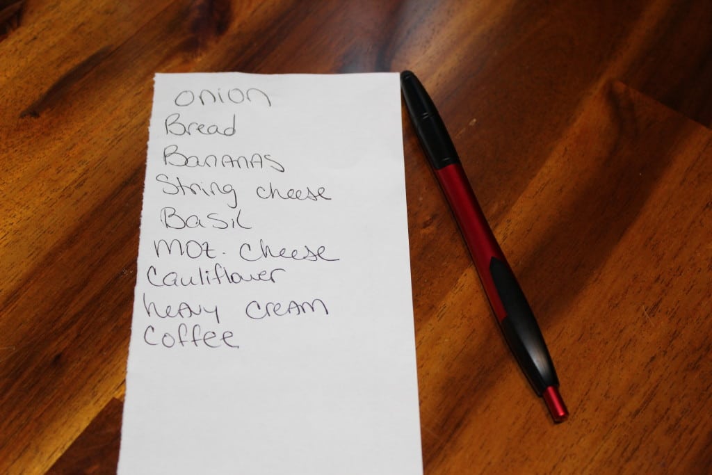 grocery list stating onion, bread, bananas, string cheese, basil, mozarella cheese, cauliflower, heavy cream, and coffee