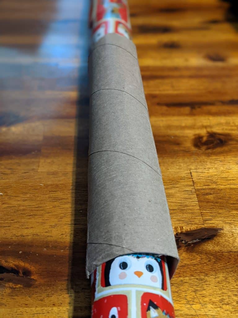 using toilet paper tube to hold wrapping paper