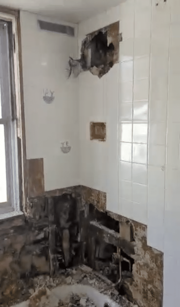 Destroyed bathroom shower missing tile, bathfitter Before photo